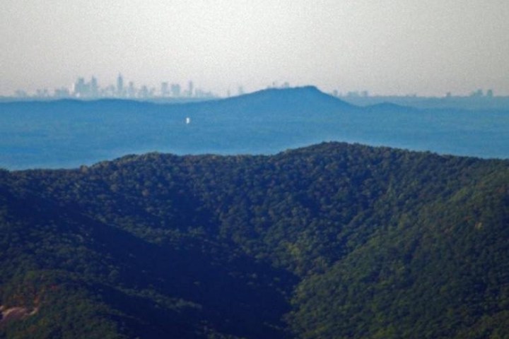 a body of water with a mountain in the background