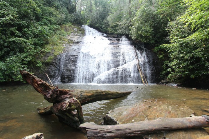 a large waterfall in a forest