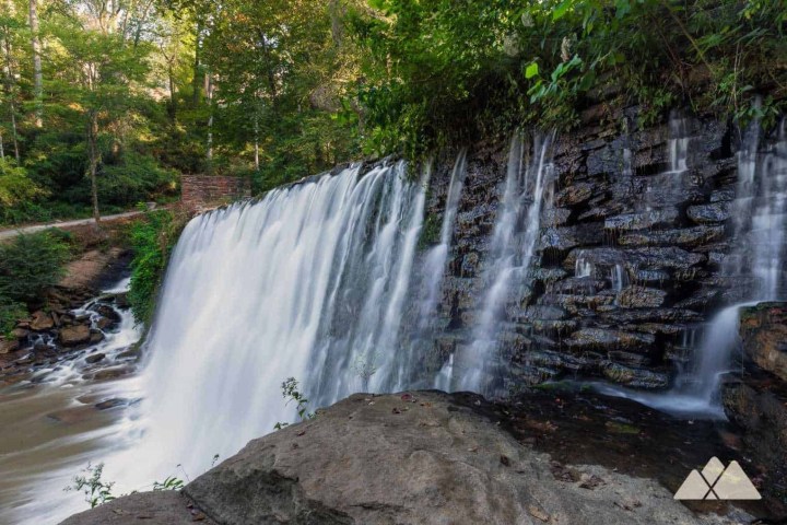 a large waterfall over some water